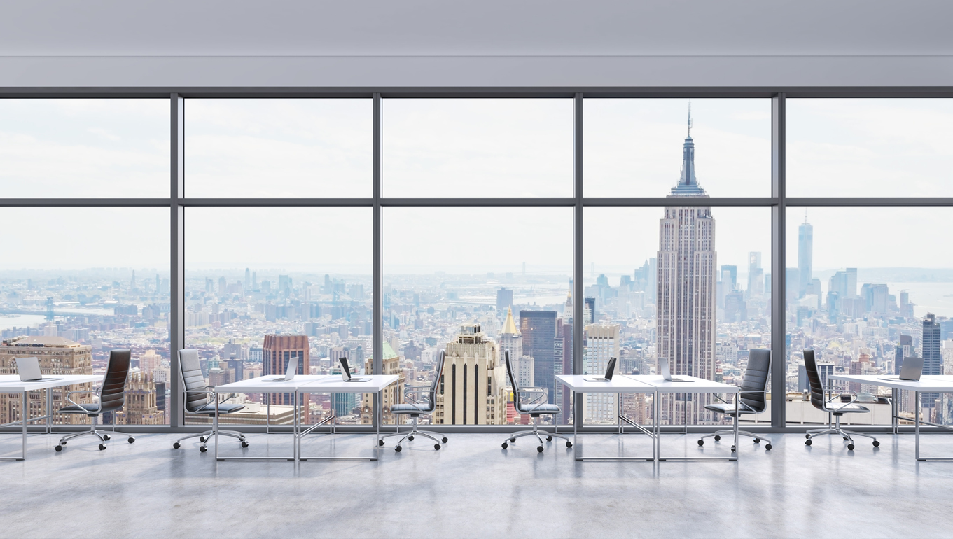 Workplaces in a modern panoramic office, New York city view in the windows, Manhattan. Open space. White tables and black leather chairs. A concept of financial consulting services.