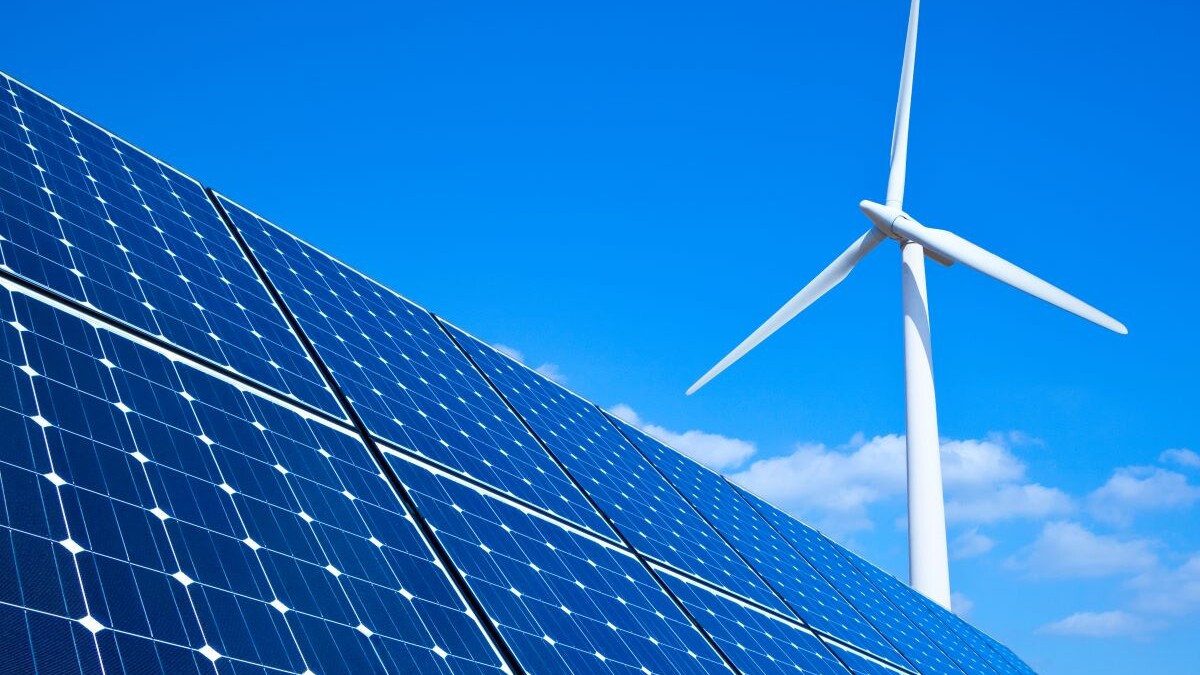 solar panels and wind turbine representing renewable energy