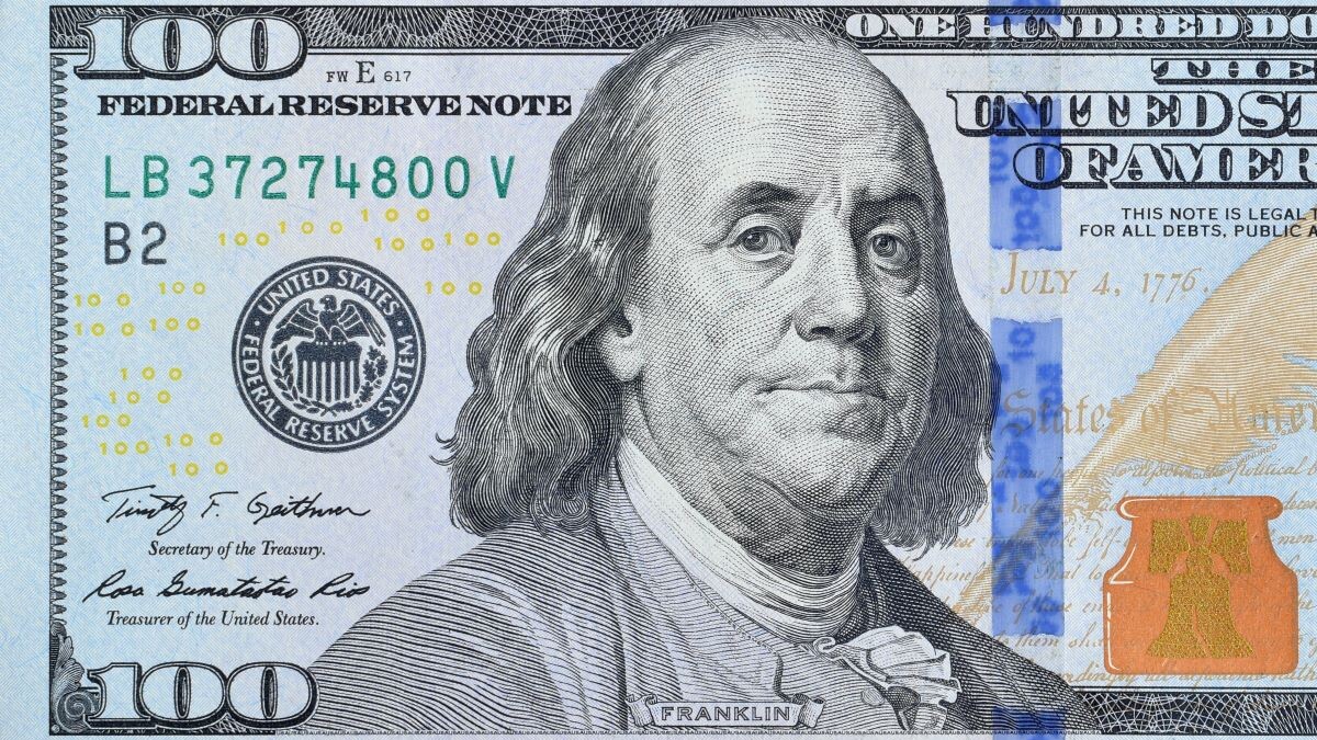 Portrait of US president Benjamin Franklin on 100 dollars banknote closeup macro fragment. United states hundred dollars money bill