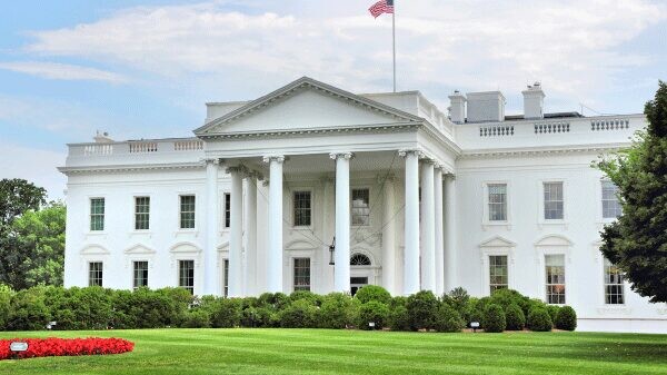 View of the White House during the daytime, showing the green landscaping.