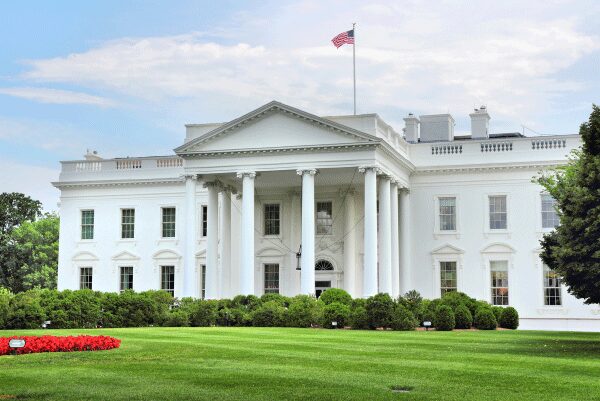 View of the White House during the daytime, showing the green landscaping.