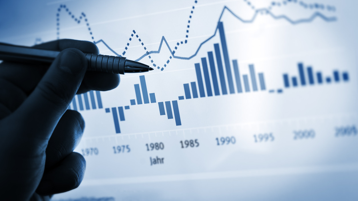 Hand pointing with pen on a computer chart / document