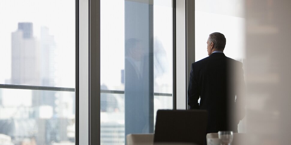 businessman looking out office window