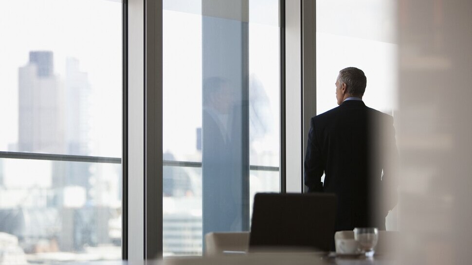 businessman looking out office window