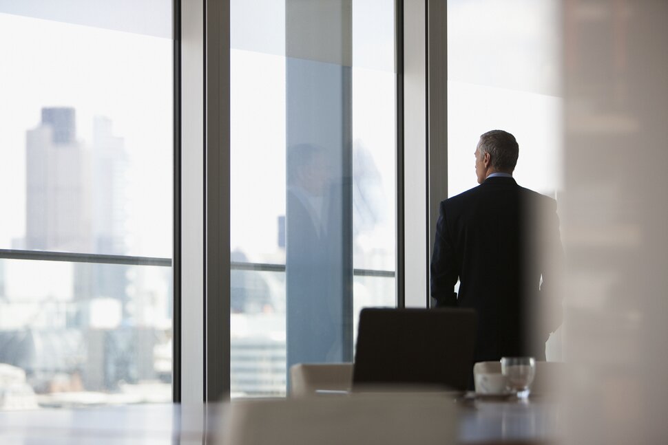 businessman looking out office window