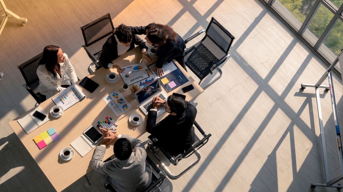igh angle view of business woman advise patner with empathy during meeting session in office, diversity business people, financial discuassion, good relationship in work place
