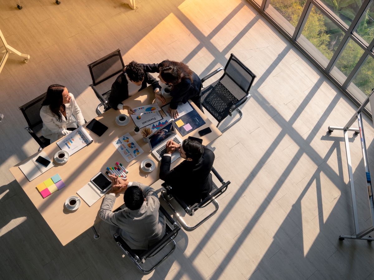 igh angle view of business woman advise patner with empathy during meeting session in office, diversity business people, financial discuassion, good relationship in work place