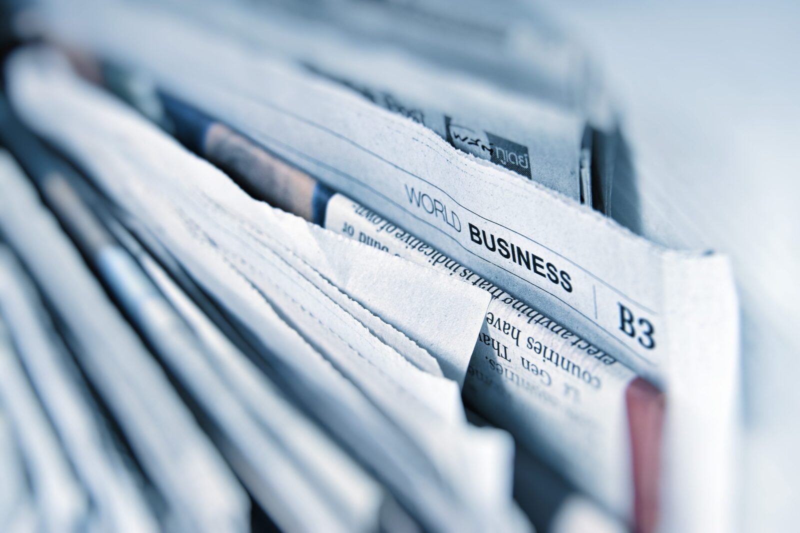 newspaper pile with business page showing