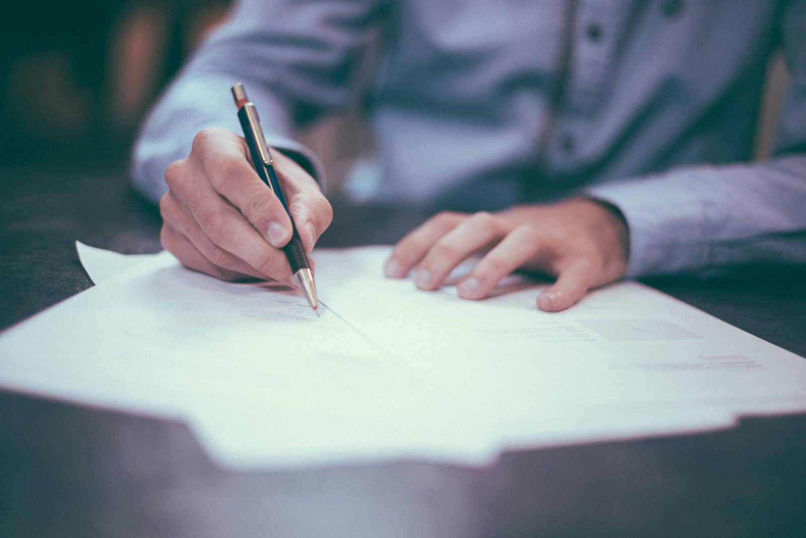 consultants hands writing on paper at desk