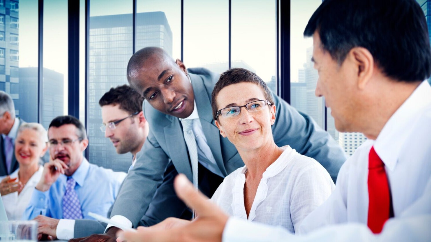 Business people sitting around a boardroom table.