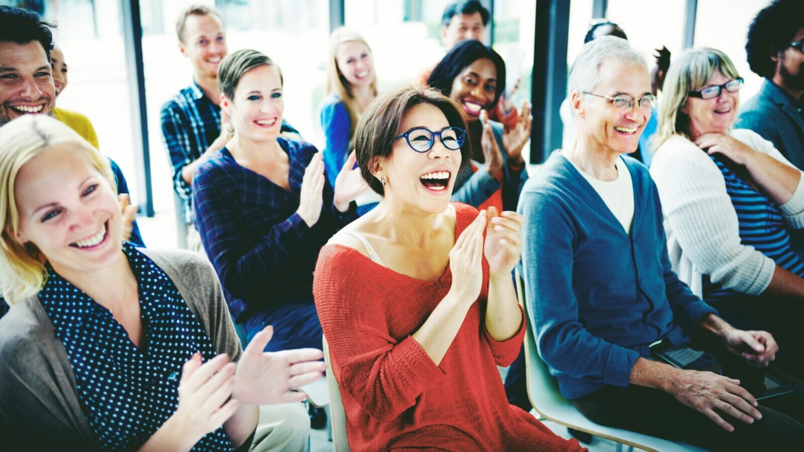 Seated viewers clapping.