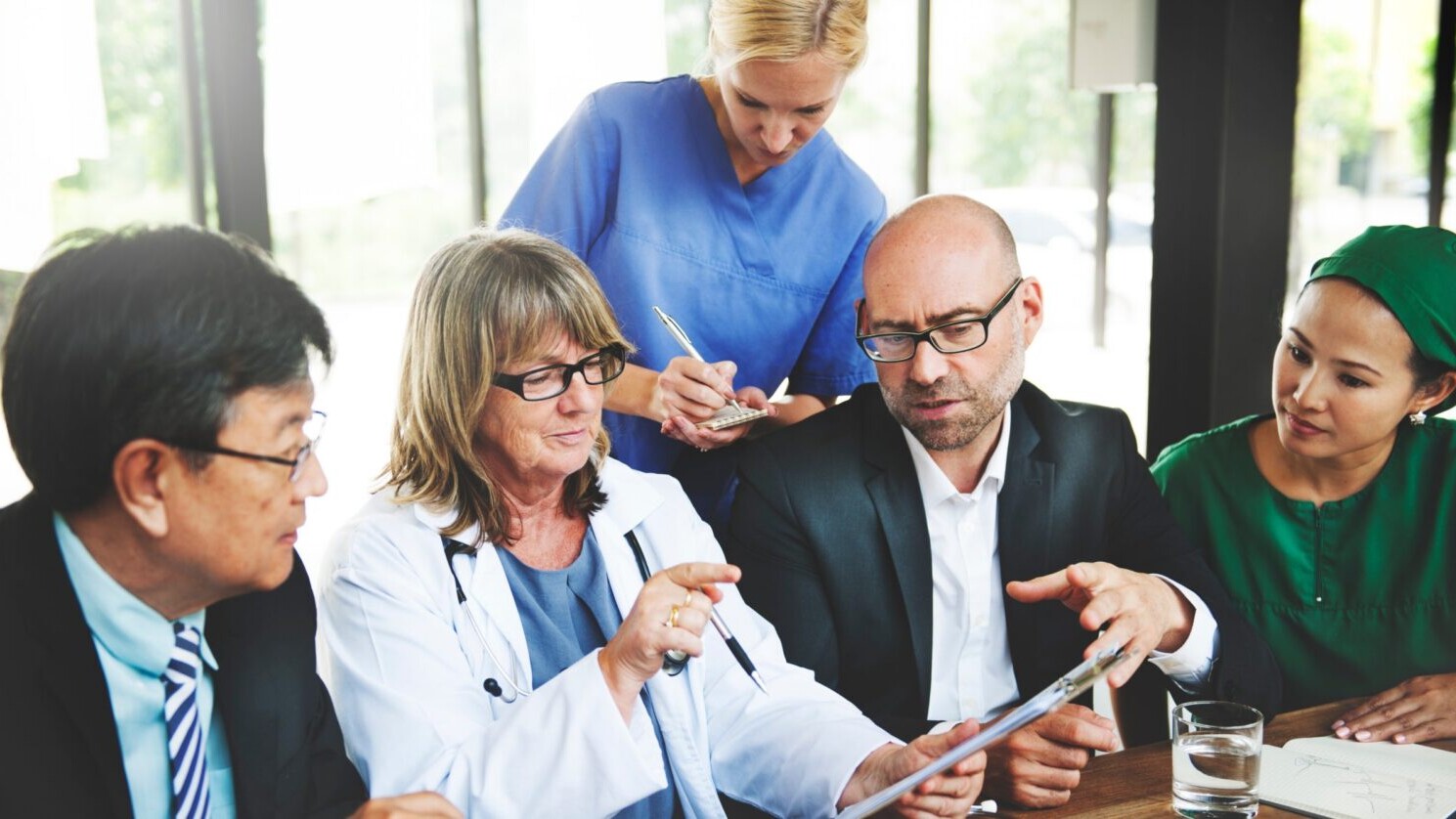 Health care workers reviewing a file.