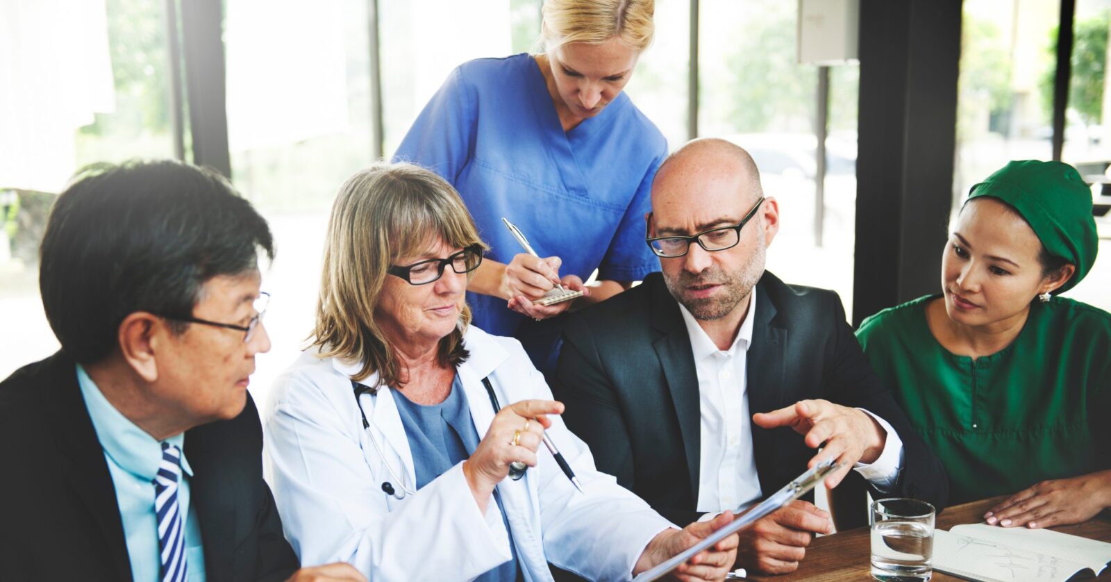 Doctors and healthcare workers in a meeting.