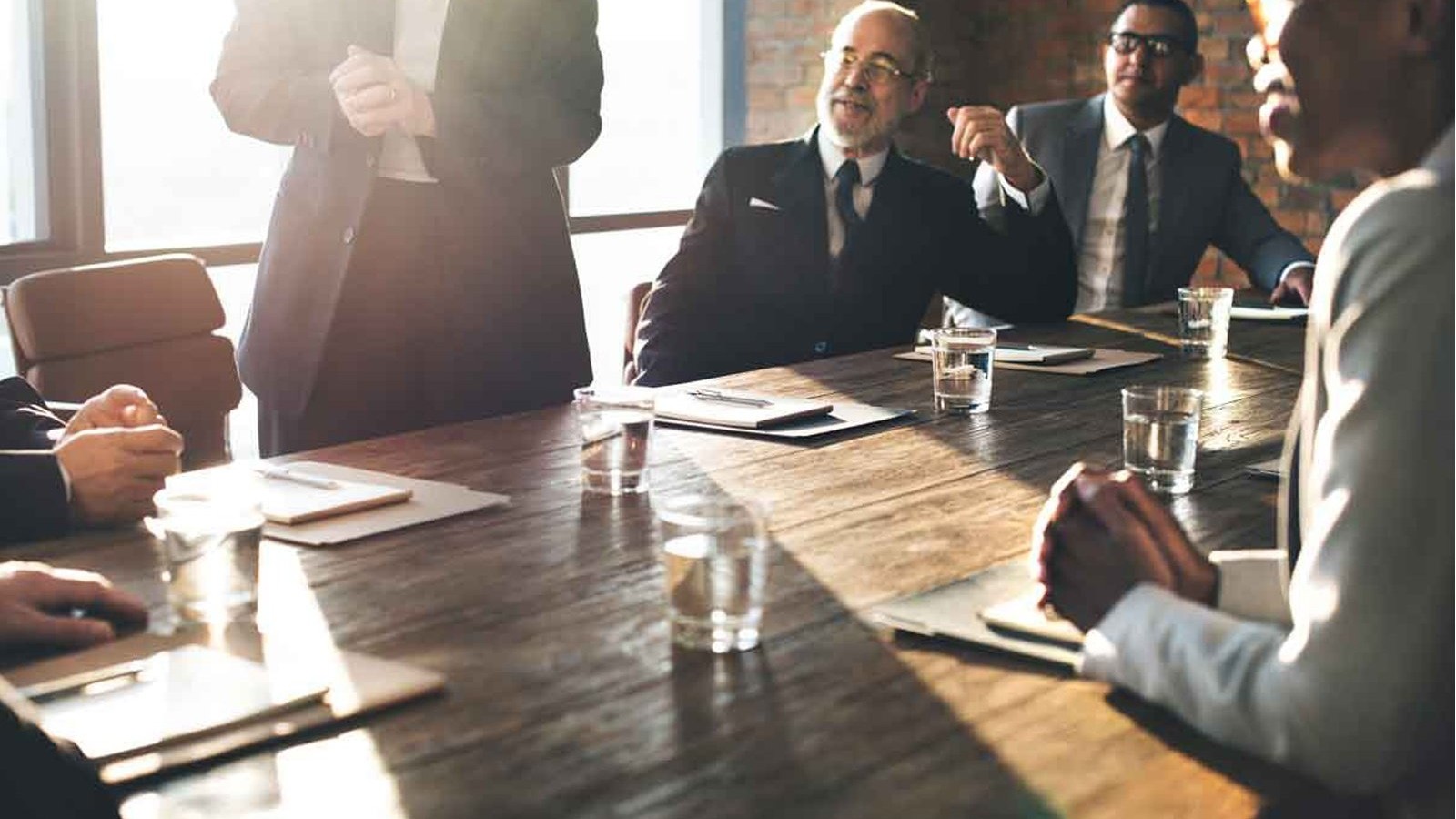 Workers seated around a conference table.