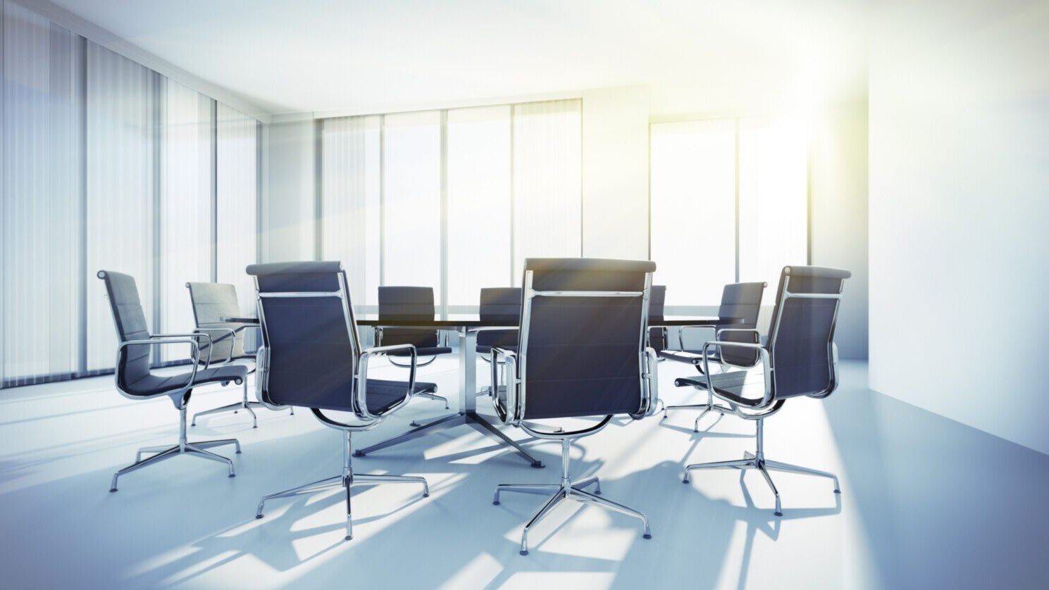 A sunlit empty conference room.