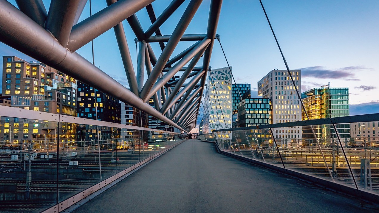 Glass enclosed skyway in a city setting.