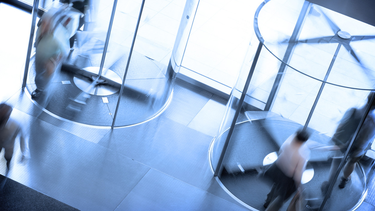 People going through a pair of revolving doors