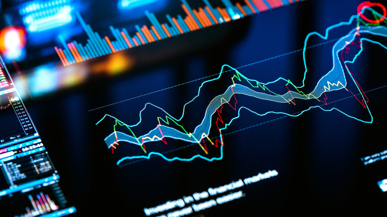 Trading charts and data background on pixelated screen