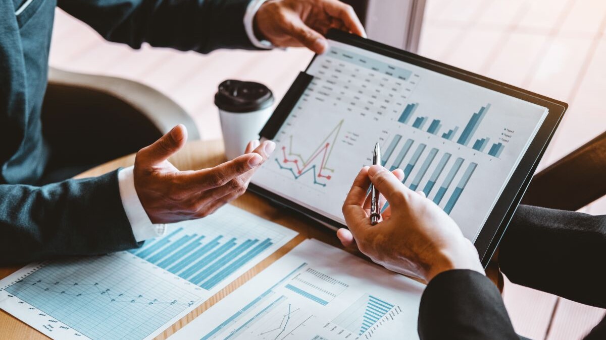 two people reviewing charts and financial documents