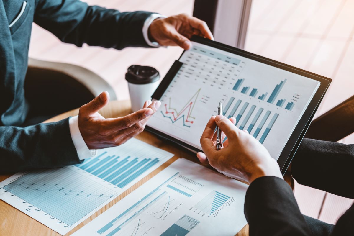 two people reviewing charts and financial documents