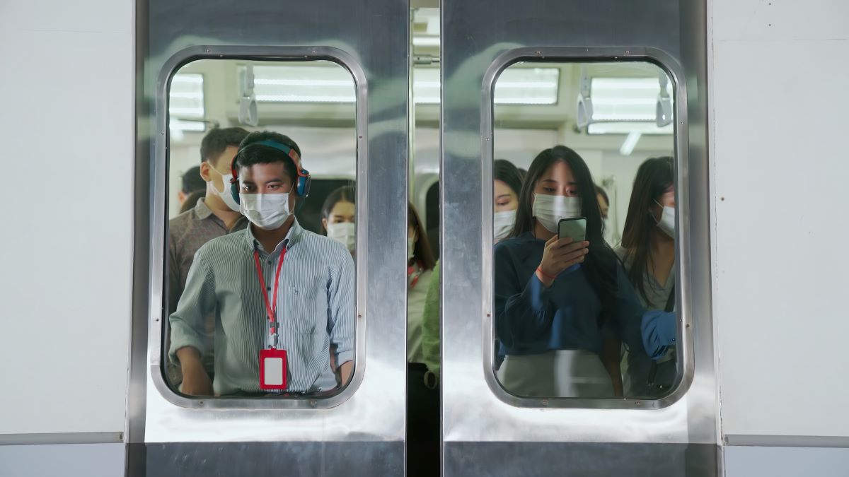 Crowd of people wearing face mask on a crowded public subway train travel . Coronavirus disease or COVID 19 pandemic outbreak and urban lifestyle problem in rush hour