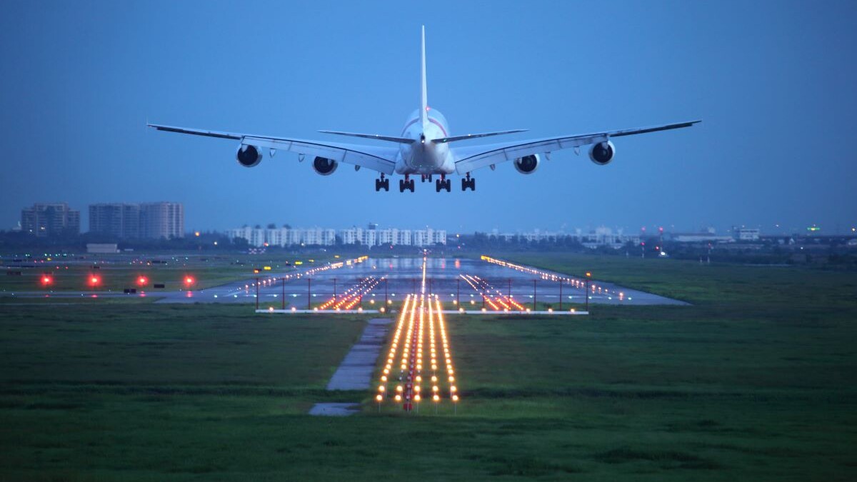 passenger plane flying up over take-off runway from airport