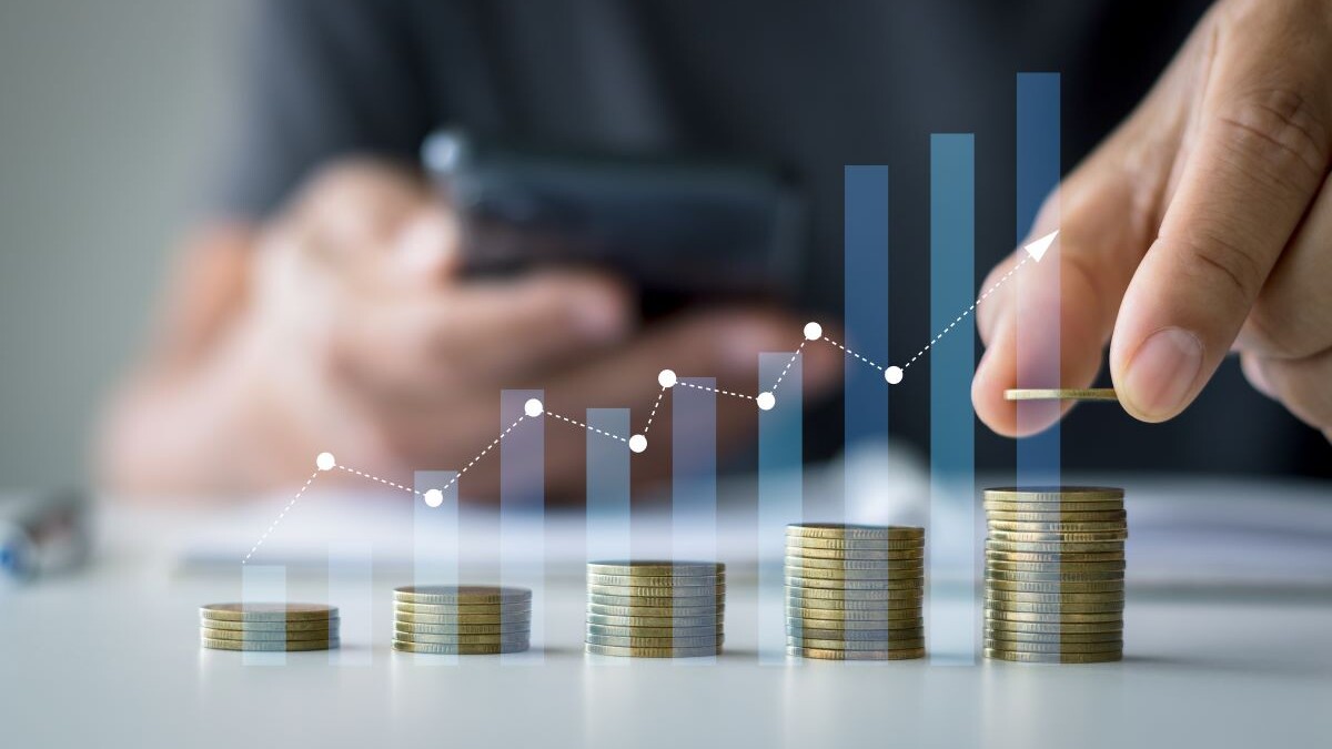 Savings and Investment concept. Concept of saving money for finance accounting to arrange coins into growing graphs concept. businessman holding a coin putting on stack coins.
