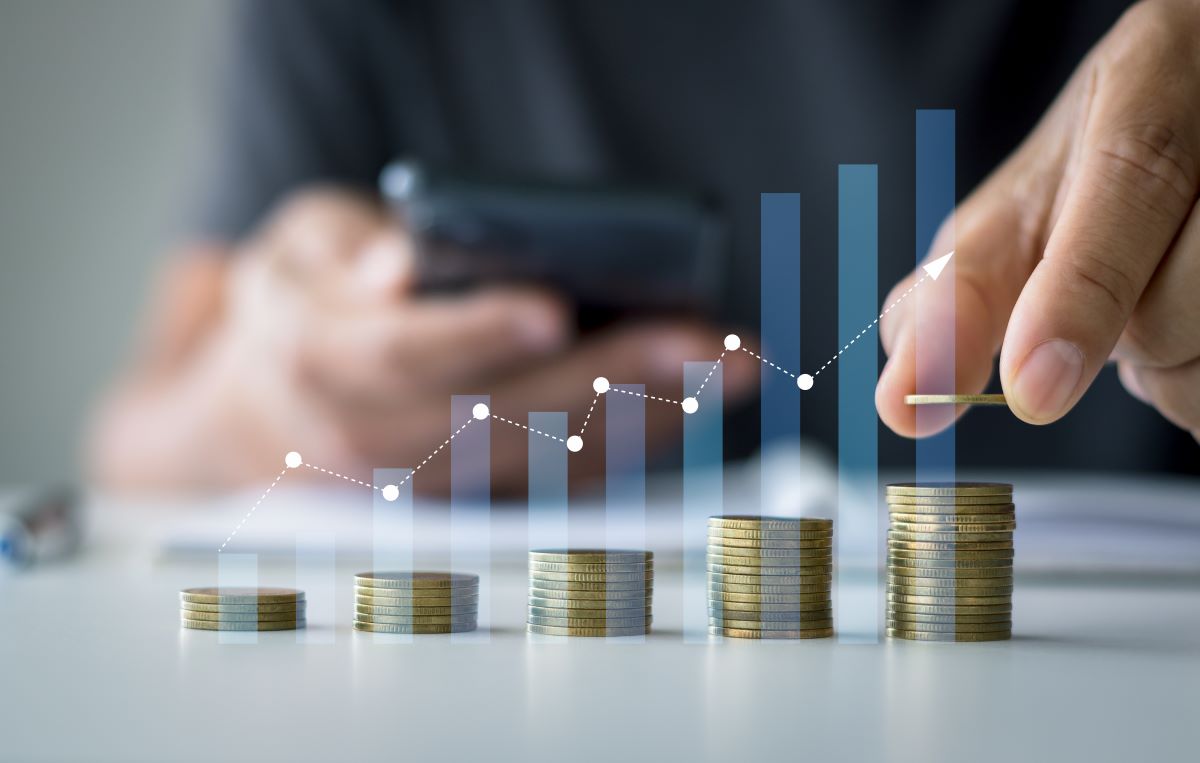 Savings and Investment concept. Concept of saving money for finance accounting to arrange coins into growing graphs concept. businessman holding a coin putting on stack coins.