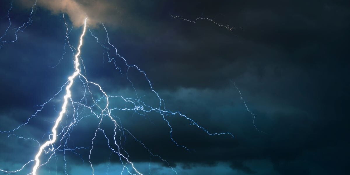 storm clouds and Fork lightning striking down during summer storm