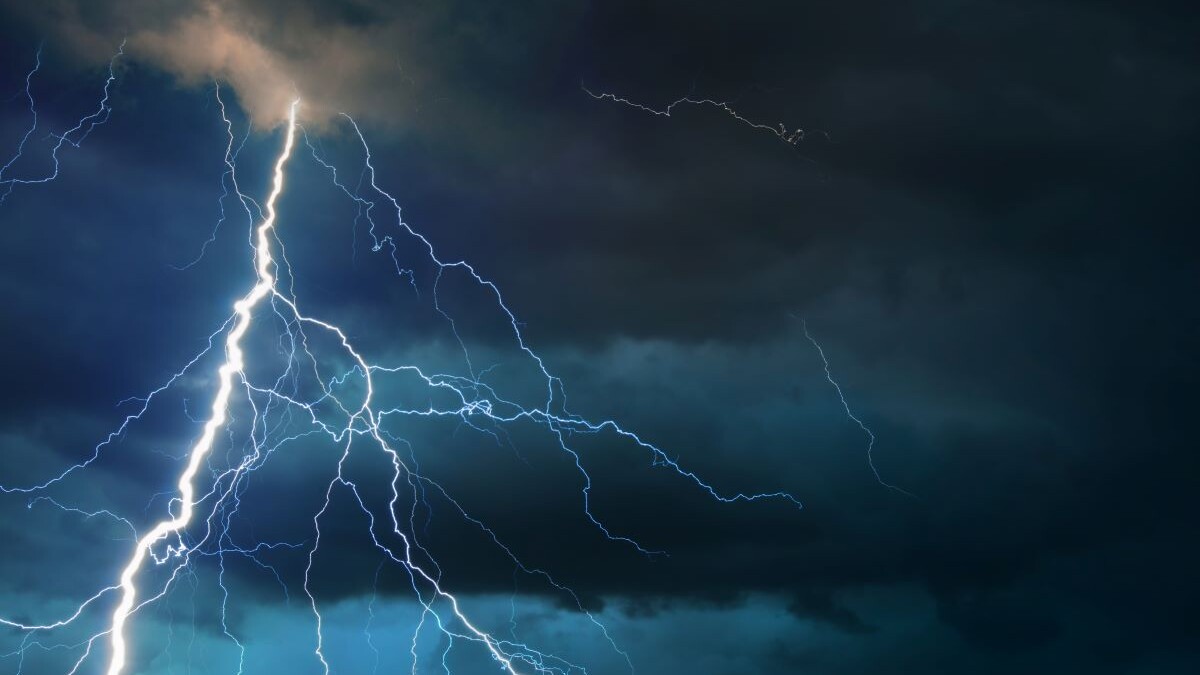 storm clouds and Fork lightning striking down during summer storm