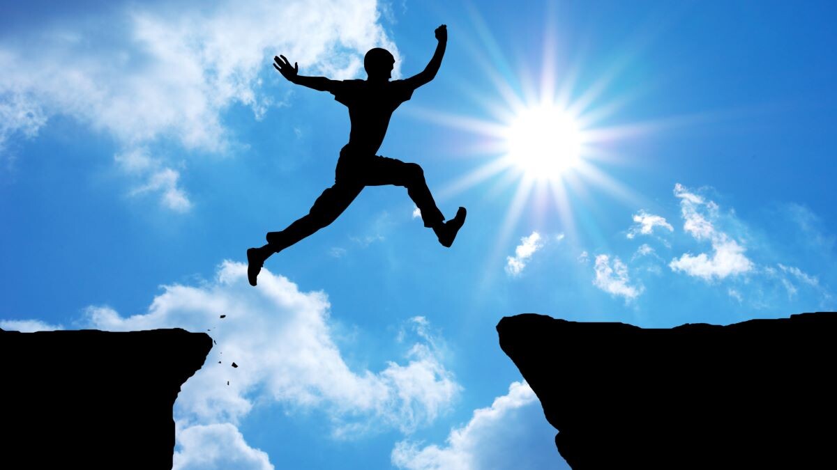 Man jumping between rocks