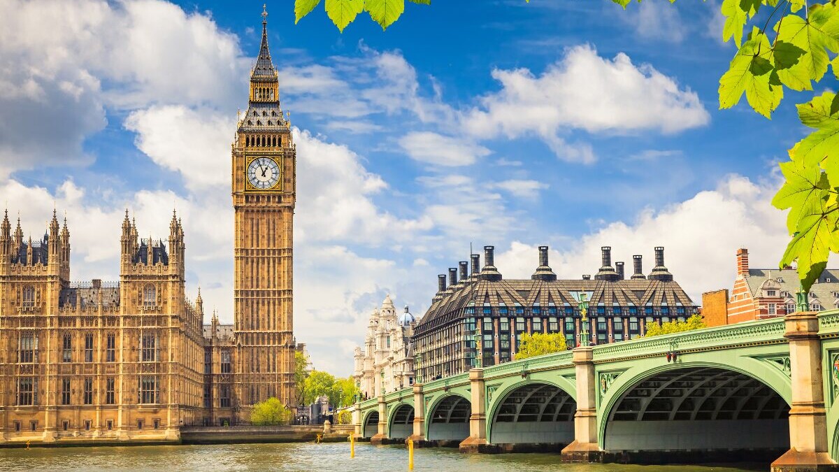 Image of London clock tower overlooking river and bridge