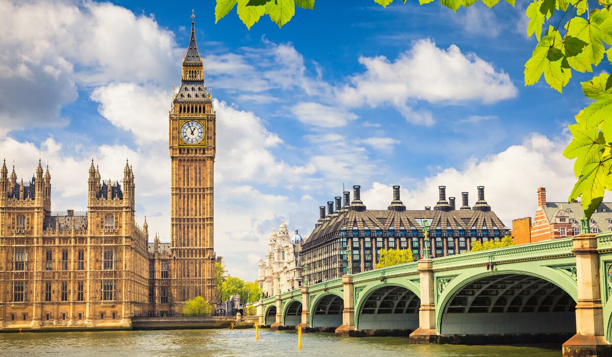 Image of London clock tower overlooking river and bridge