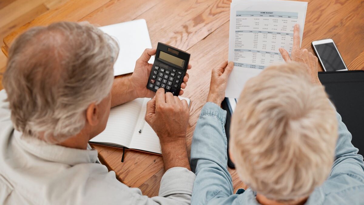 senior couple with calculator planning financial investments