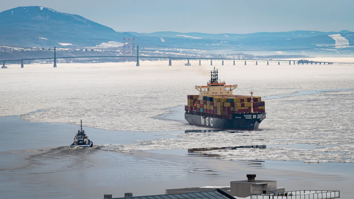 An MSC cargo vessel heads up the St. Lawrence River from Quebec City, Canada in the winter accompanied by a small tugboat on Feb. 15, 2023. Import Tariffs. Trade Sanctions.