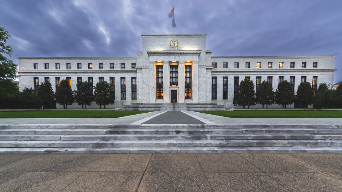 Washington DC—Oct 24, 2021; Steps and pathway leading to front entrance of the United States Federal Reserve bank illuminated at dusk with cloudy sky