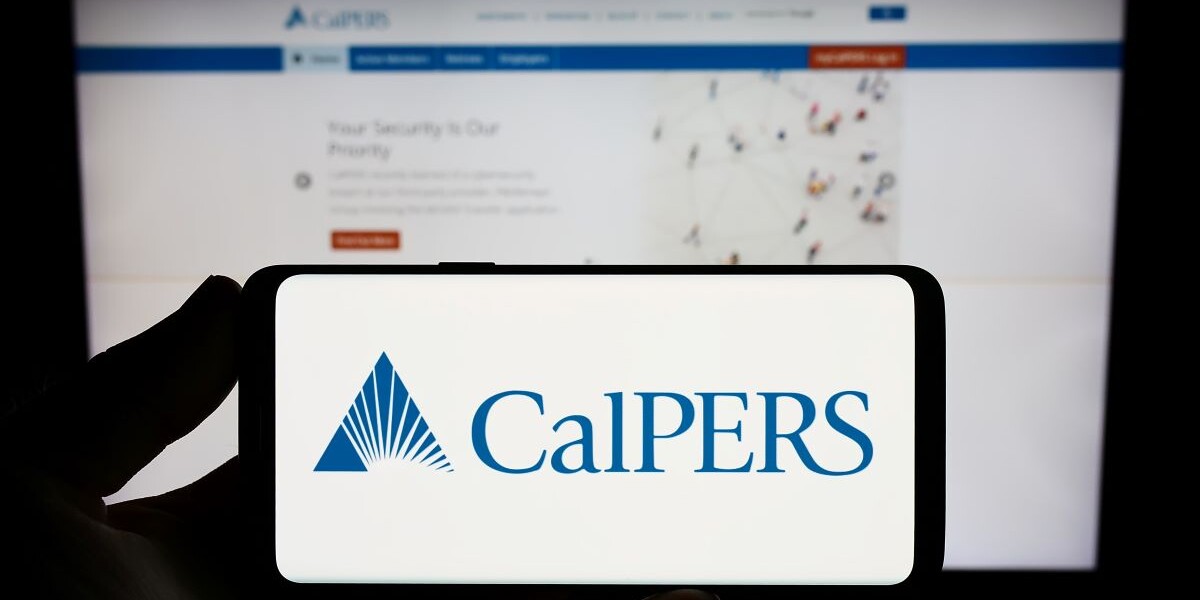 Stuttgart, Germany - 07-12-2023: Person holding smartphone with logo of Californian retirement system CalPERS on screen in front of website. Focus on phone display.