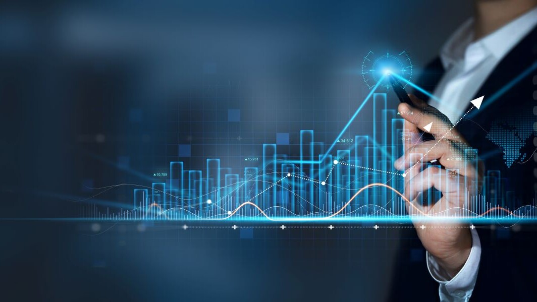 Businessman with pen draws growth graph of business.