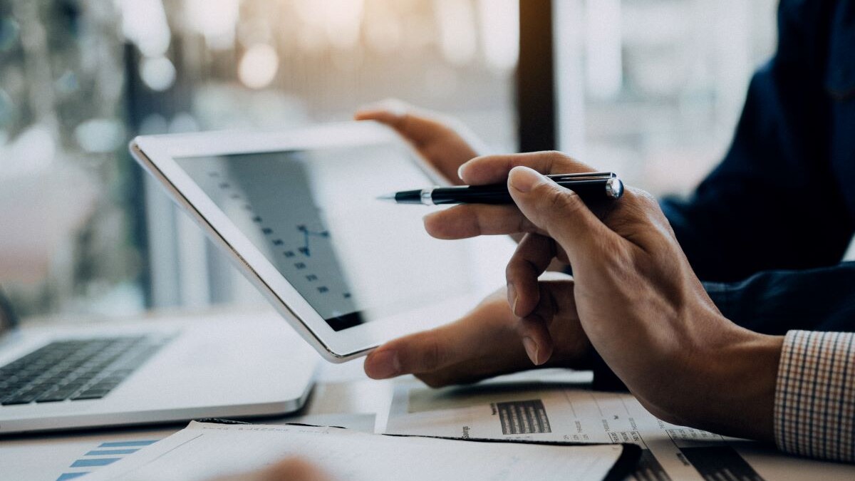Business partnership coworkers using a tablet to analysis graph