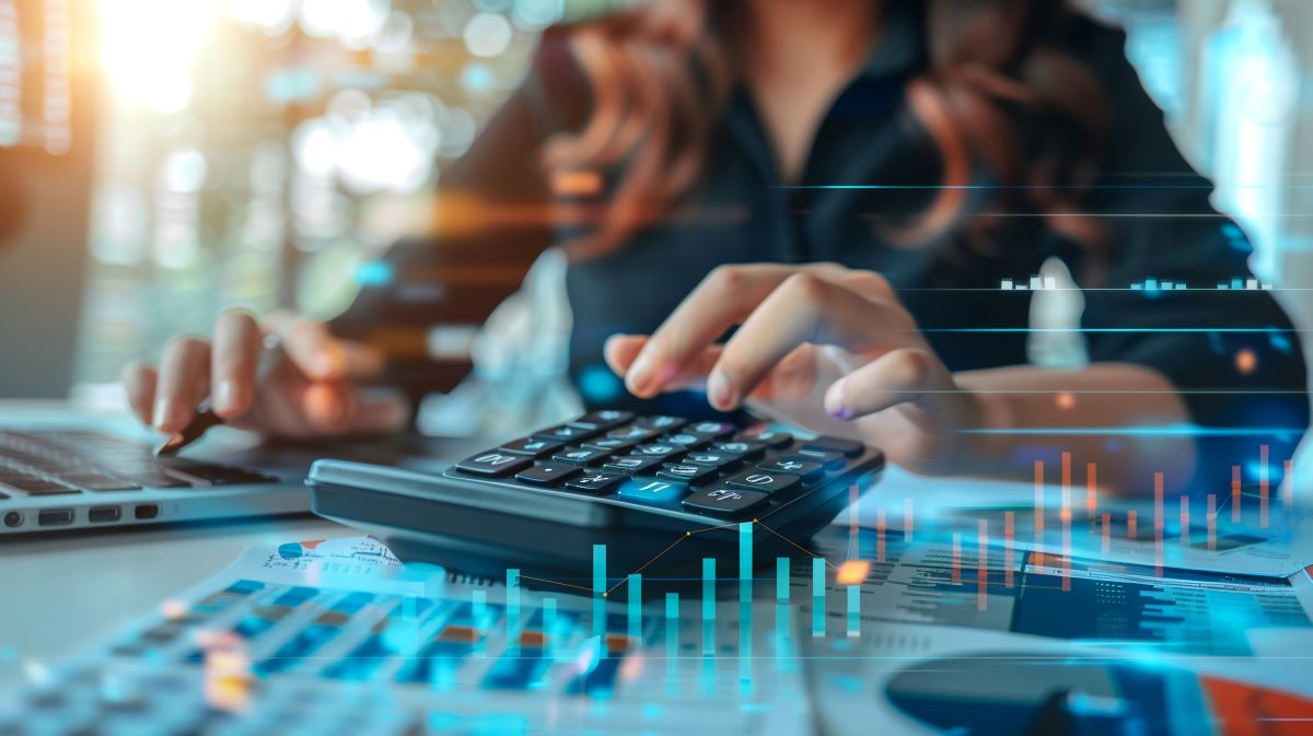 Business finance and accounting concept. Businesswoman using calculator to calculate financial report