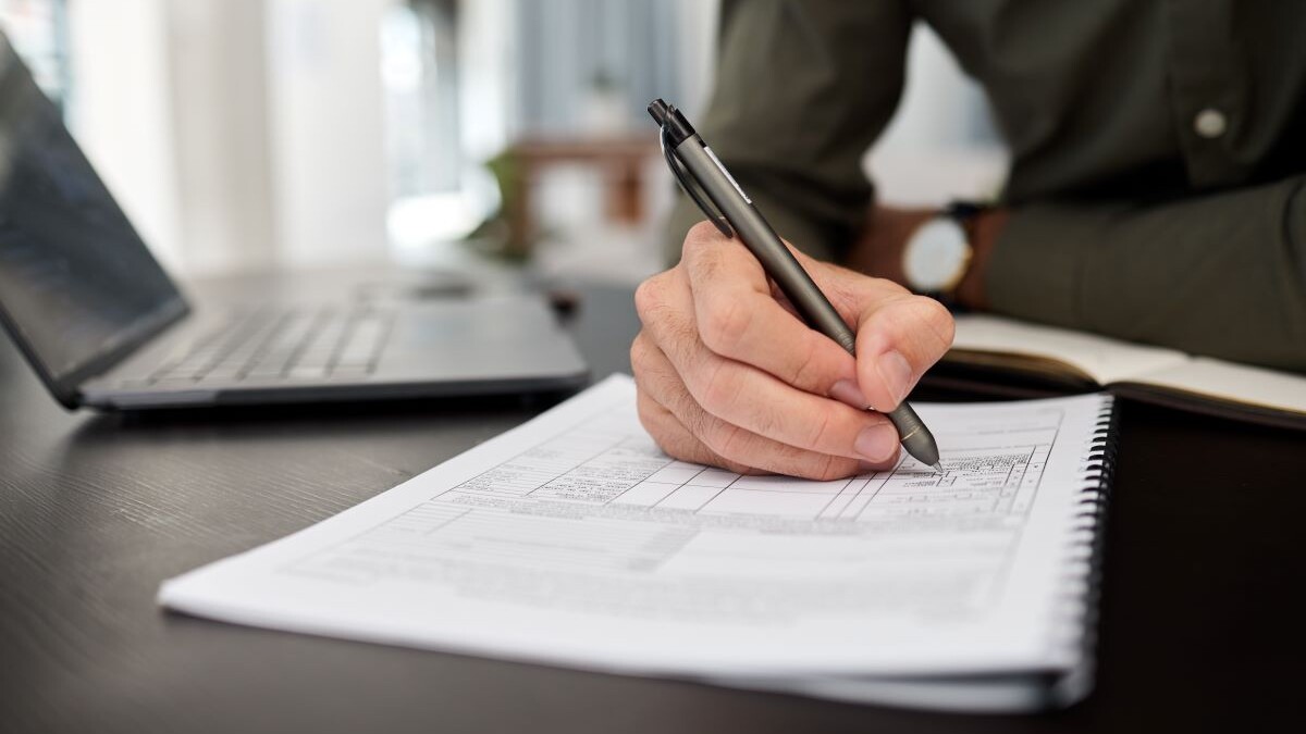 Documents, accounting and hands of business man in office for checklist, planning and finance. Tax, payment and budget report with closeup of person for investment, survey and invoice paperwork