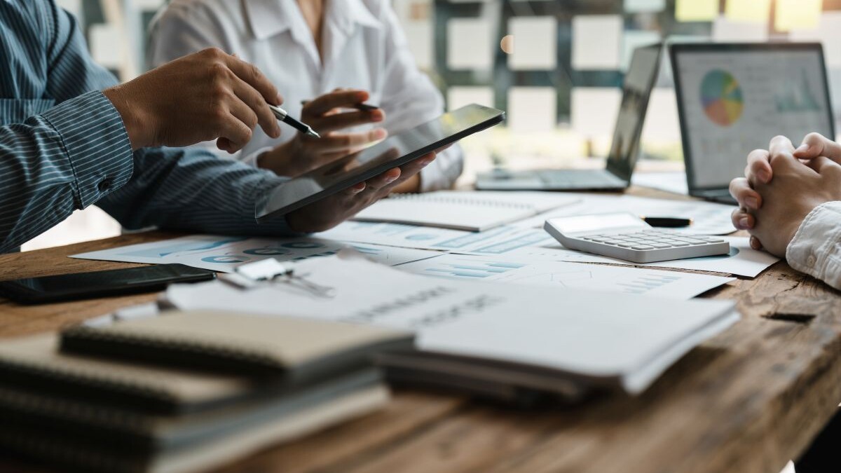 business adviser meeting to analyze and discuss the situation on the financial report in the meeting room.Investment Consultant, Financial advisor and accounting concept