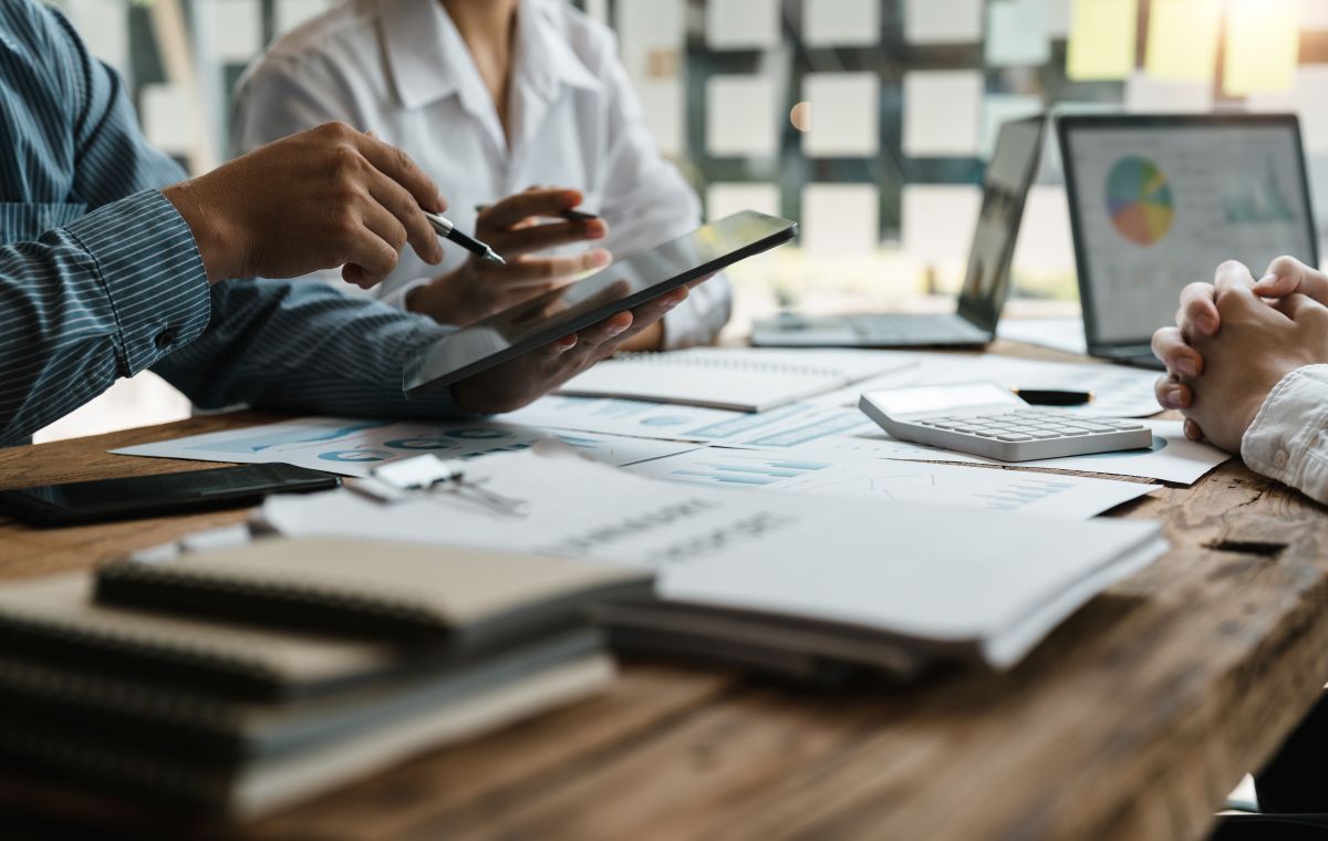 business adviser meeting to analyze and discuss the situation on the financial report in the meeting room.Investment Consultant, Financial advisor and accounting concept