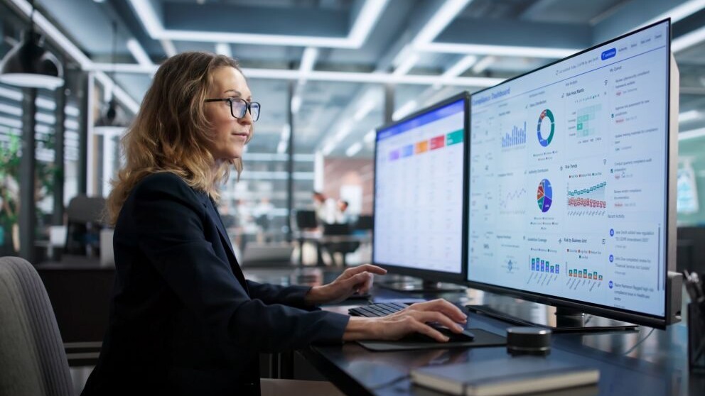 Compliance Officer Monitors Business Security Regulations With Dashboard