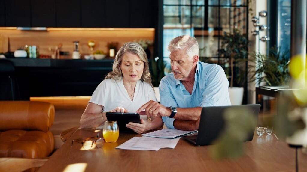 Tablet, planning and budget with old couple at home for social security benefits, annuity growth and retirement fund. Account balance, online banking and 401k withdrawal with people