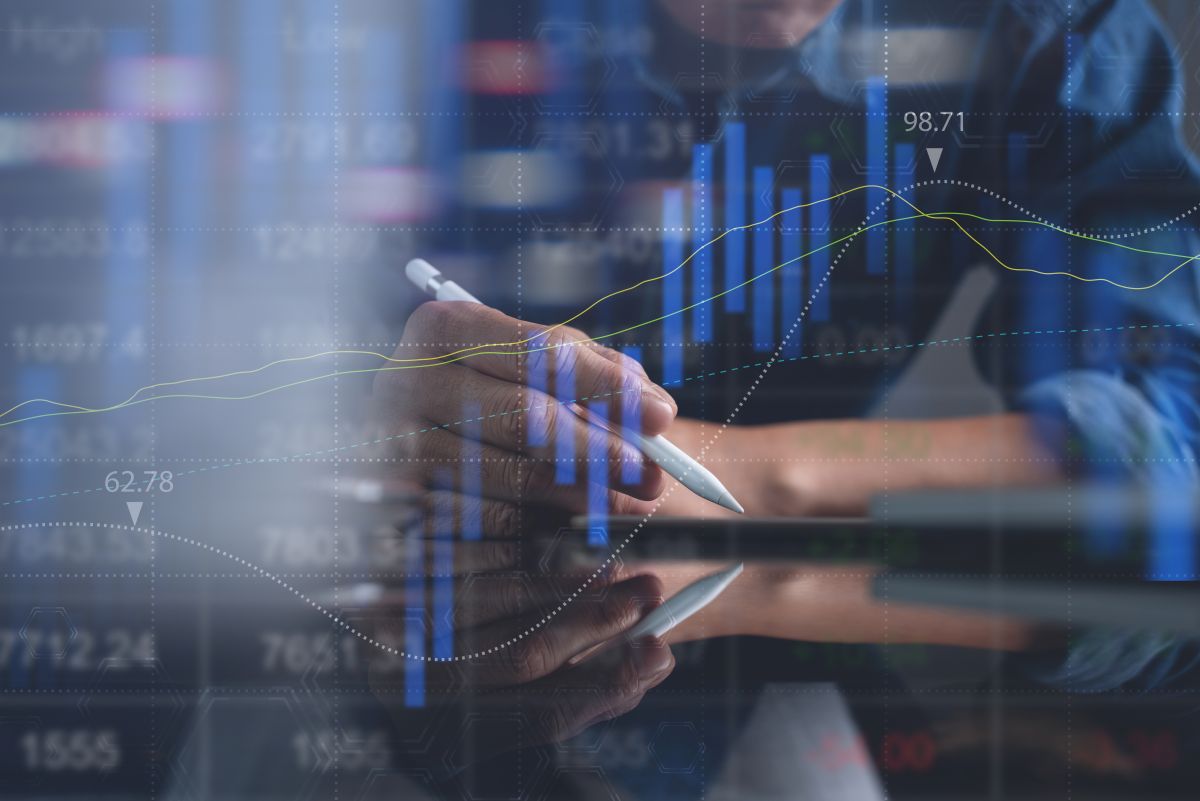 Business man analyzing stock market report with financial graph