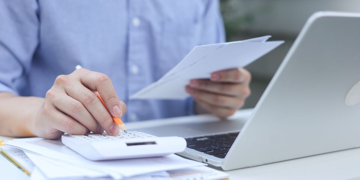 close up man hand press on calculator and check invoice letter from bank to check about debt